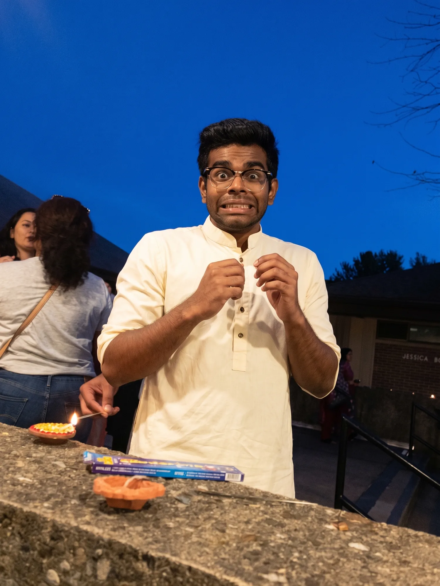 Abhijeet in a kurta with his hands raised, looking nervous